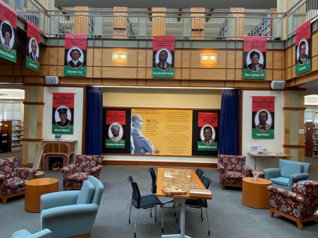 Living Room in Cary Library with The Association of Black Citizens of Lexington’s Black History Portrait Banners hanging down from the Atrium.